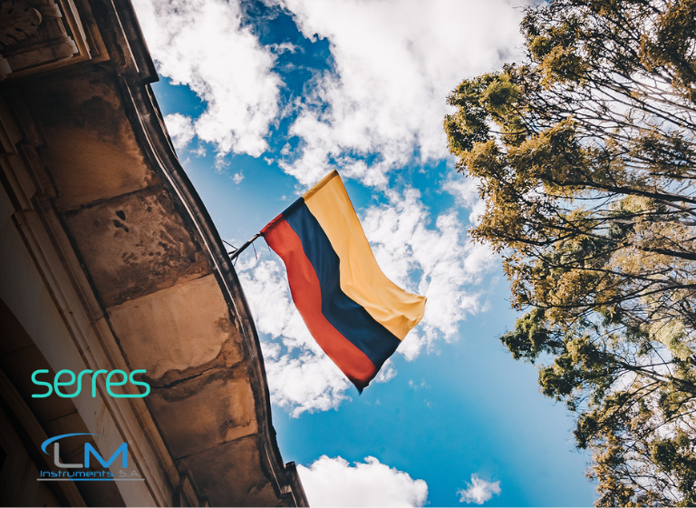 Colombian flag waving in the wind, with logos by Serres and LM INstruments S.A
