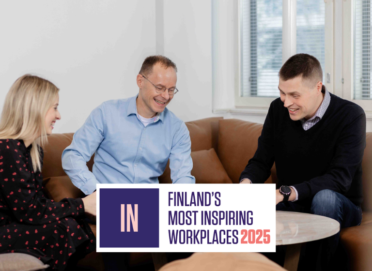 Serres employees in a meeting room discussing and smiling.